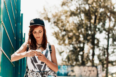 Attractive urban girl using a mobile phone.の写真素材