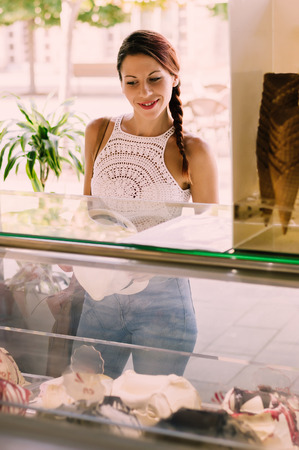 Beautiful woman ordering ice creamの写真素材