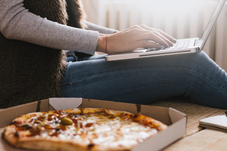 Side view of businesswoman using computer at home.の写真素材