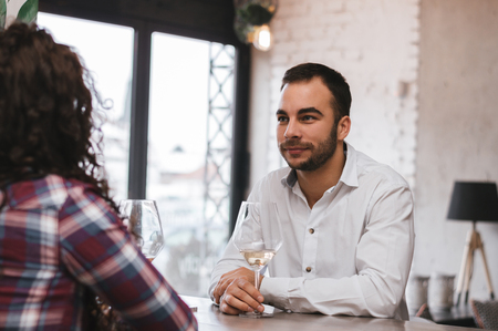 Portrait of couple having a glass of wine in a barの写真素材