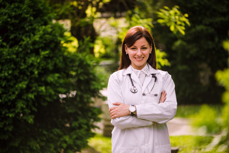 Portrait of young smiling confident female doctor outdoorsの写真素材