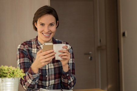 Portrait of a beautiful young business woman enjoying her first morning coffee and preparing for workの写真素材
