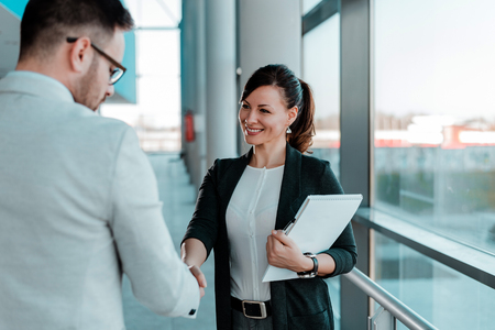 Two smiling business people handshake. Good business deal.の写真素材