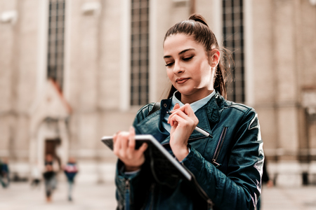 Attractive tourist woman taking notes.の写真素材