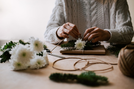 Lovely handmade gift wrapping with natural paper, rope, pine branches and flower.の写真素材
