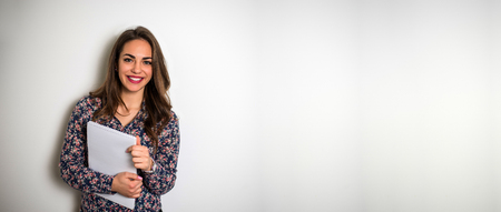 Portrait of woman holding documents on isolated background.の写真素材