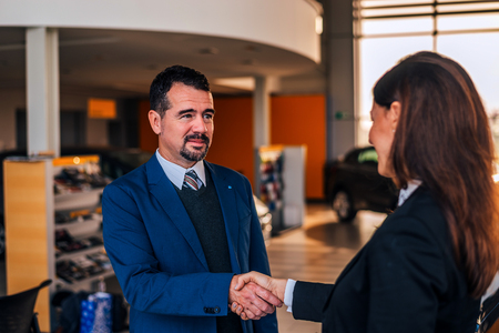 Mature businessman shaking hands with car dealer.の写真素材