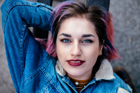 Top view of a beautiful girl lying outdoors. Looking at camera.の写真素材