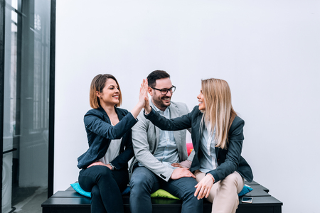 Coworkers high-five after successful startup .の写真素材