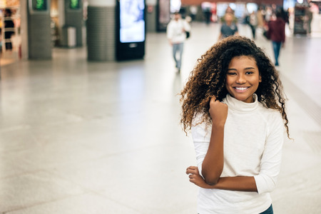 Portrait of smiling young woman at mall.の写真素材