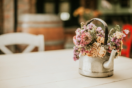 Cozy home rustic decor. Flowers on teapot.の写真素材