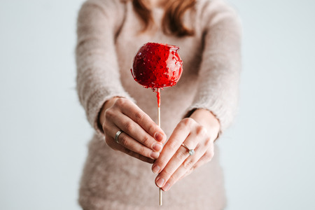 Attractive woman holds holiday sugar candy on stick.の写真素材