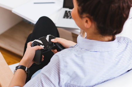 Girl holding joystick while playing video game
