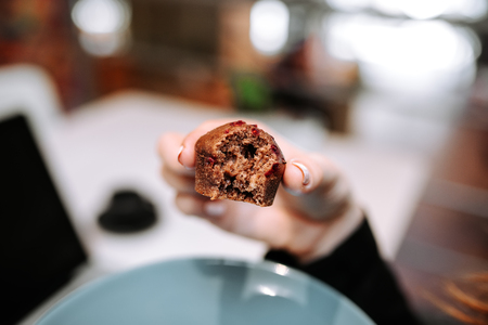 Eating cupcake. Close-up.の写真素材