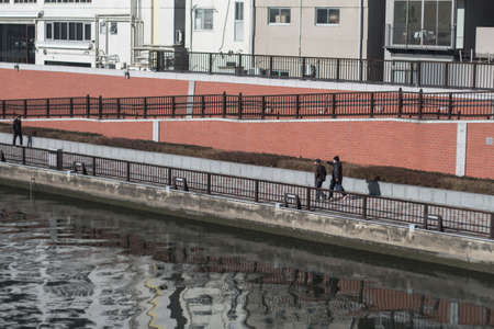 16 February 2017, Tokyo, Japan. A pedestrian near canal in Japan backgroundのeditorial素材