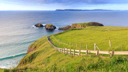 Carrick-a-Rede Rope Bridge  is a famous rope bridge near Ballintoy in County Antrim, Northern Ireland. The bridge links the mainland to the tiny island of Carrickarede.の写真素材