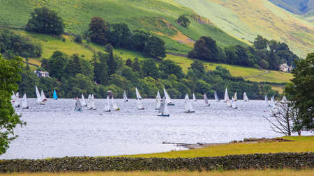 Lake District, UK - July 5, 2014 : People are playing windsurf in the lake at lake district, UK.