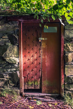 Old wooden door with nature large brick in UK urpan.の写真素材