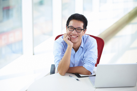 Young asian businessman working in the officeの写真素材