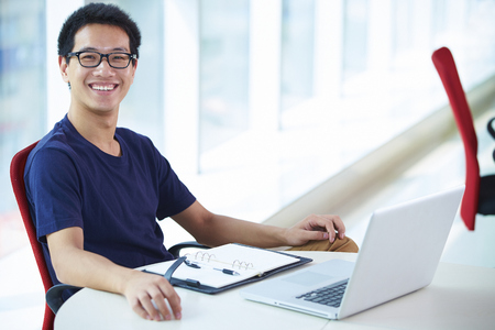 Young asian businessman working in the officeの写真素材
