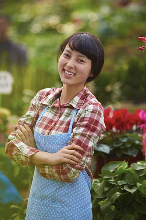 One Beautiful Chinese Woman Working in the Florist's Smile at Cameraの写真素材