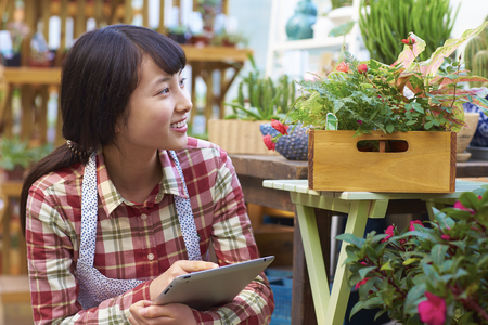 Chinese Woman Working in the Florist's Smile at Cameraの写真素材