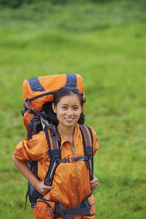 One young Asian woman Carrying her Backpack hiking in the natureの写真素材