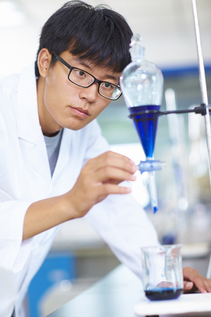 One male Chinese Laboratory scientist working at lab with test tubesの写真素材