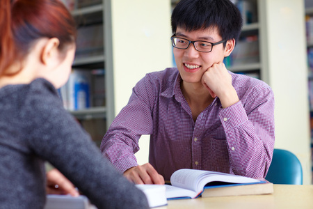 two asian college students study in the libraryの写真素材