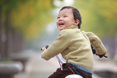 happy little asian girl outdoorの写真素材