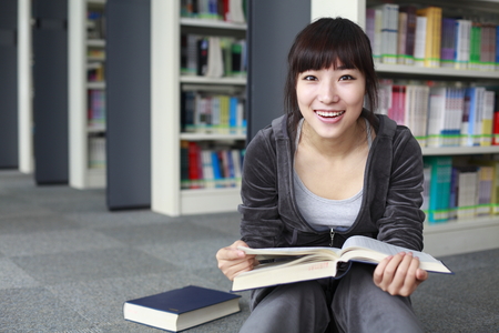 portrait of young college student in the libraryの写真素材