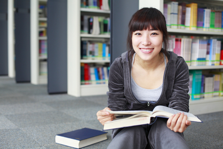portrait of young college student in the libraryの写真素材