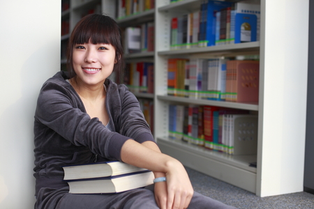 portrait of young college student in the libraryの写真素材