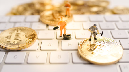 Bitcoin with little figure on keyboard