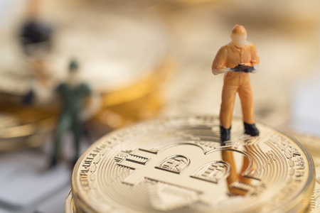 Bitcoin with little figure on keyboardの写真素材