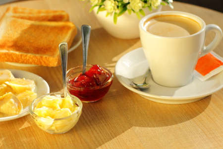 Coffee, toasted bread and butter for breakfastの写真素材