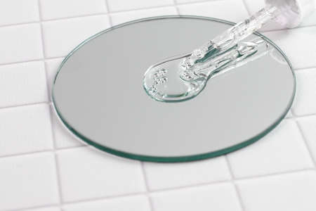Pipette, dropper with serum drops on mirror, cosmetic techologies