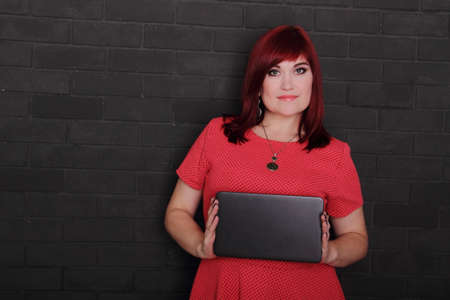 Young red hair woman showing blank board