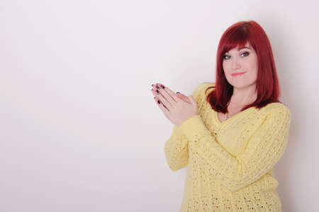 Young woman showing finger up, copy space