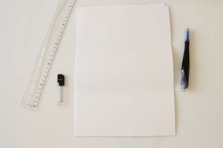 A4 paper on office table, supplies, pen, phone, blank paper