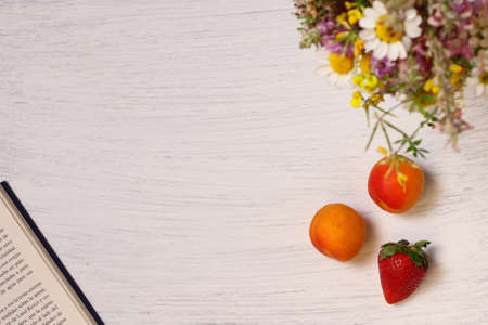 Breakfast book and flowers on wooden table, copy space