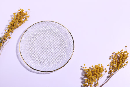 Empty glass and flowers decoration on table, mock upの写真素材