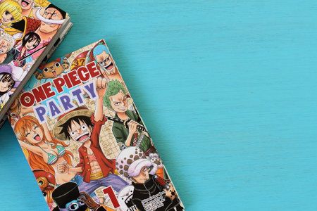 One piece manga book in blue table, japanese comic style in Spanish, Vitoria, Spain, July of 2022のeditorial素材