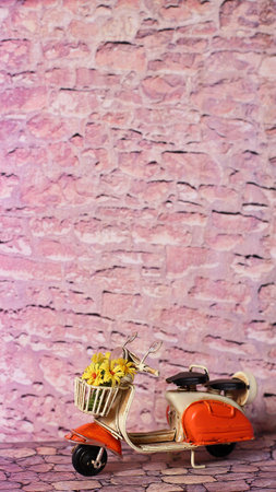 Vintage scooter, flowers bouquet, on the street, on stone wall backgroundの写真素材