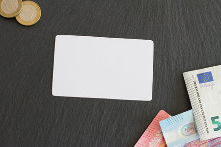 Credit card format mock up on table with euro money