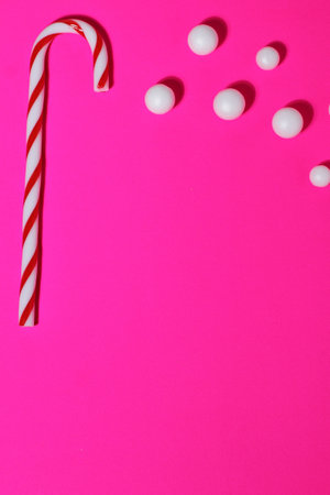 Red striped cane, Christmas candy on magenta backgroundの写真素材