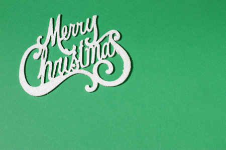 Merry Christmas card on green background, copy space