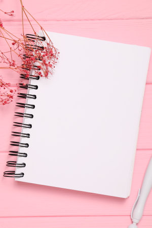 Blank white notebook sheet on wooden background, copy spaceの写真素材
