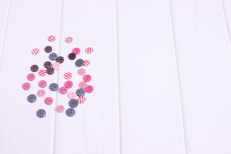 Group of colorful buttons for sewing on wooden tableの写真素材