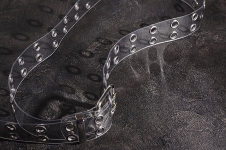 Transparent plastic belt with metal silver decor, clothes accessories